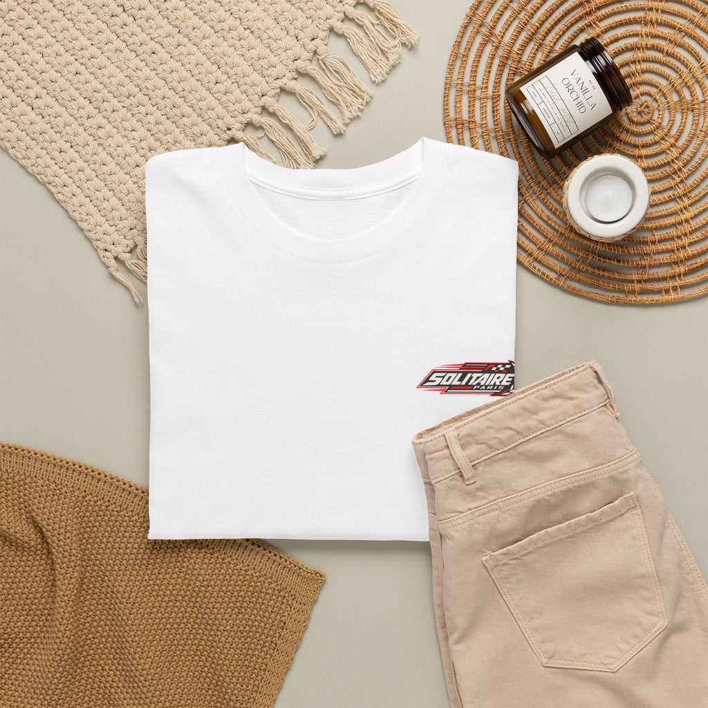 White Solitaire Paris t-shirt paired with beige trousers and home decor accessories.